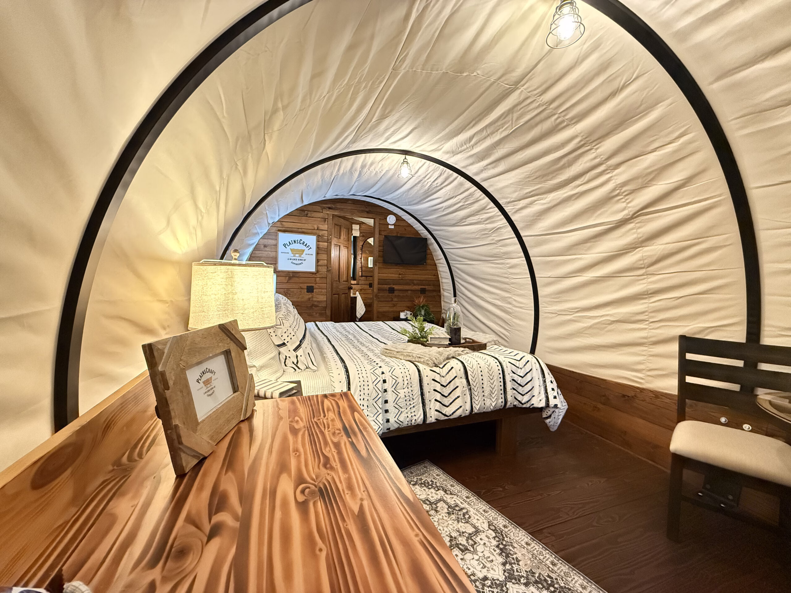 Side view of Pioneer Elite wagon interior with queen bed and ensuite bathroom